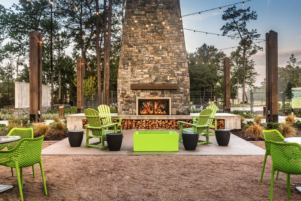 Residents can cozy up next to The Hearth accompanied with some a comfortable seating area with adirondack chairs.