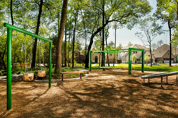 Discovery Square offers innovative park elements including mirrored stumps, a dragon swing, picnic tables in the trees, a group spinner and art within nature pieces.