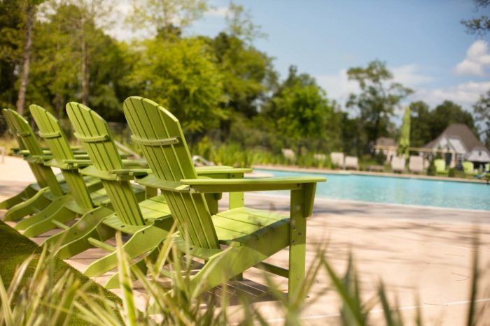 Relax by the resort-style pool in our unique adirondack chairs located in The Hearth Amenity Center.
